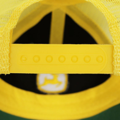 Close-up of a yellow cap with a logo on a black background